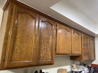 a kitchen with wooden cabinets and counter tops